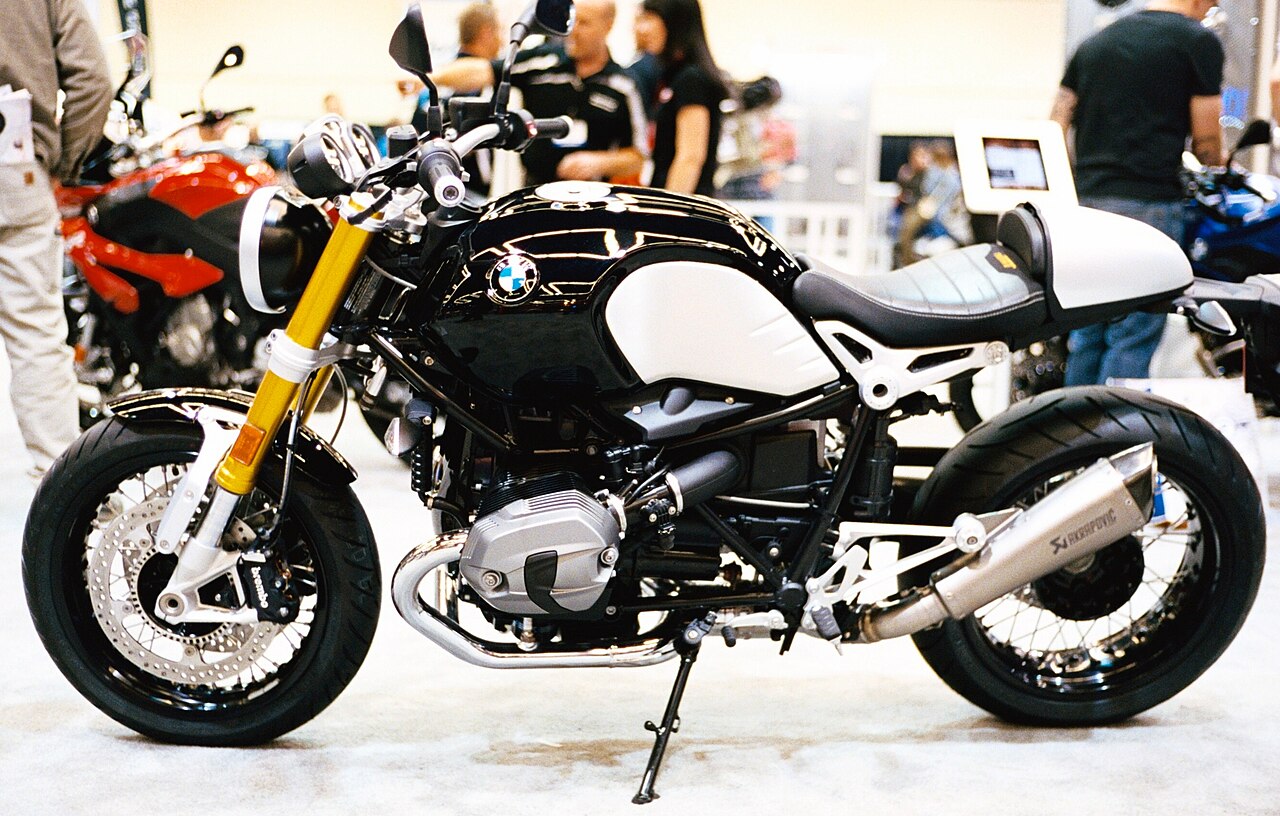 Black and silver BMW R nineT shown from the left at the Seattle motorcycle show in November 2014, with a solo-seat cowl and twin exhaust silencers